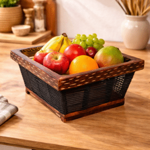 Handcrafted wooden fruit basket with apples, bananas, grapes and orange on table
